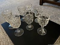 Seven assorted cut crystal stemmed glasses