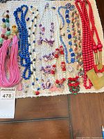Full lot overview showing variety of beaded jewelry laid out