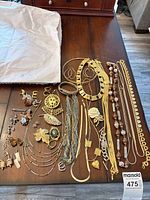 Entire lot laid out showing necklaces, bracelets and brooches
