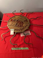 Full view of round metal sun wall art with rays and measurement tape