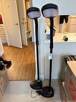 Full view of both Verilux floor lamps standing side by side