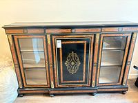 Front view of three-door ormolu display cabinet