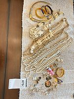 Full lot laid out showing variety of necklaces, bracelets, earrings
