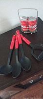 Full set on table: four utensils, two tin canisters in wire rack