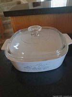 Casserole with lid assembled, front view showing floral motif