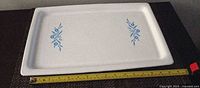 Top view of entire tray showing blue Cornflower decals and measuring tape