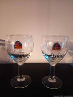 Two Leffe stemmed goblets front view showing logos