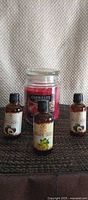 Front view showing candle and three oils