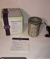 Warmer, box and paperwork displayed together