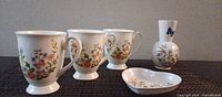 Full set of three mugs, vase, dish on placemat