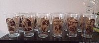 Front view of all 12 Coca-Cola collector glasses