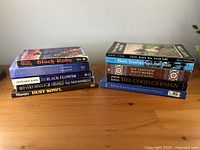 Front view of two stacks of assorted books on table