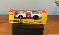 Front and side view of boxed Porsche Carrera 6 showing livery and box front
