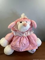 Front view of the pink Puffalump lamb plush showing face, hooded dress and overall appearance