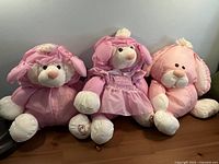 three pink Puffalump plush toys side by side