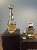 Dior J'adore bottle, Givenchy L'Interdit full-size and mini displayed