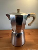 Full view of assembled Gnali & Zani Venezia stovetop espresso maker showing wood-effect handle and knob