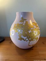 Front view of pink porcelain vase with gold floral motif