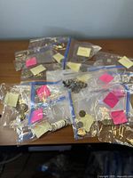 Plastic zipper bags containing sorted coins spread on table