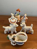 Group shot of six Occupied Japan porcelain figures