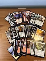 Spread of assorted Magic: The Gathering cards showing fronts, mixed colors