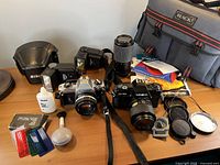Overall lot showing both cameras, flashes, zoom lens, bag and accessories