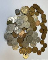 Pile of mixed silver-tone and bronze UK coins