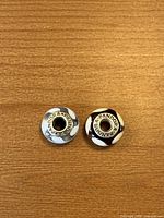 Top view showing PANDORA 925 ALE engravings on both charms