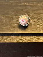 Front view of Pandora daisy charm showing enamel flower