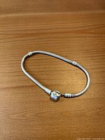 Bracelet coiled showing barrel clasp and snake chain