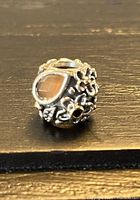 Front view showing orange moonstone and silver flower details