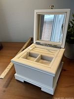 Box open showing mirror, tray, compartments