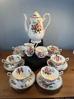 Full set arranged showing teapot, creamer, sugar bowl, six cups and saucers