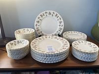 Full set displayed with stacks of dinner plates, salad plates, bread plates and soup bowls