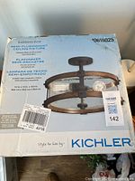 Factory sealed Kichler Barrington fixture box showing product image and details