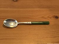 Front view of sterling silver spoon with jade handle