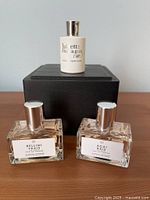 Group shot of three fragrance bottles: two rectangular Le Monde Gourmand and one cylindrical Juliette Has a Gun