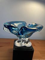 front view of blue freeform glass bowl on stand