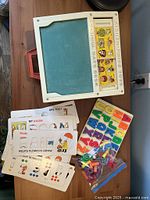 Desk with chalkboard surface, word card slot, letters, numbers and cards displayed