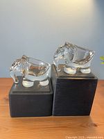 Both crystal elephant bowls side by side on display blocks