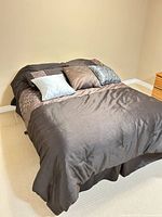 Full bed view showing comforter, shams and decorative pillows