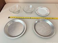 Top view of all five items with tape measure showing diameters