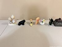 All seven decorative pieces lined left to right on table