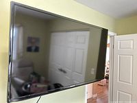 Front view of Samsung flat-screen TV mounted on wall