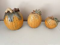 Front view of all three ceramic pumpkins
