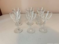 Six clear stemmed glasses front view