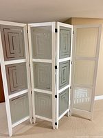 Front view of one unfolded three-panel screen showing glass panels and hinges