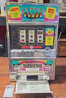 Full front view of Casino Grand slot machine with instruction sheet