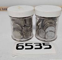 Two clear plastic jars filled with Canadian 5-cent coins