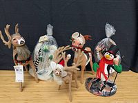Five Annalee figures displayed, including reindeer, penguin, and bagged piece